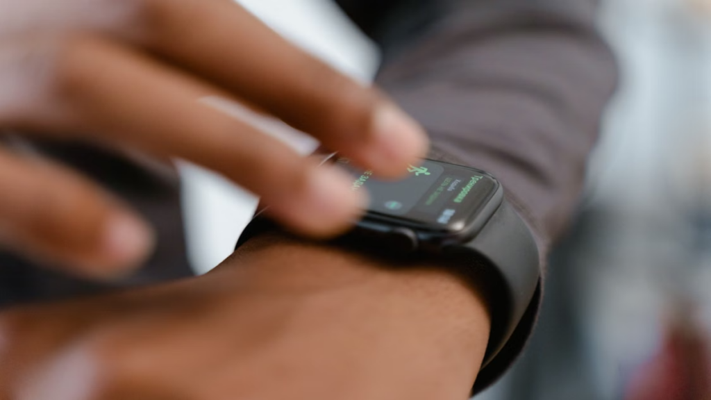 A direct comparison setup displaying three premium wearables running distinct smartwatch software update platforms