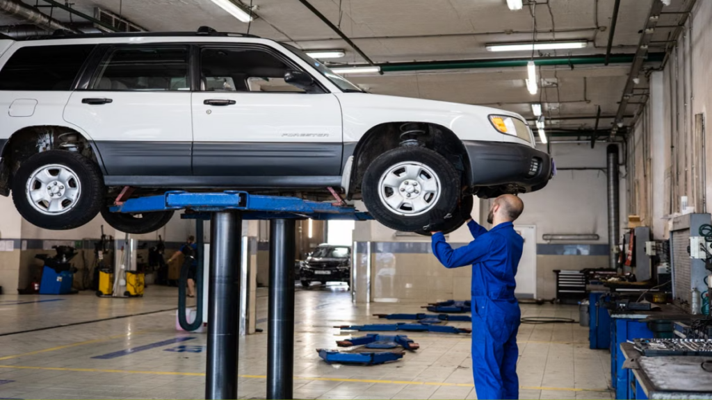 A mechanic working on the engine of reliable Old SUVs.