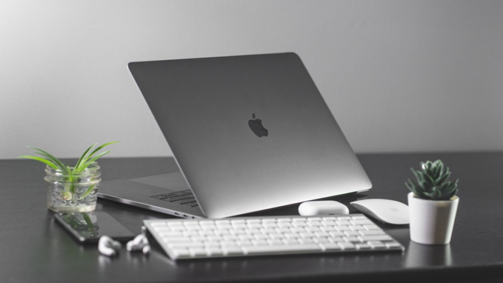 Corporate professionals utilizing Apple Refurbished MacBooks.