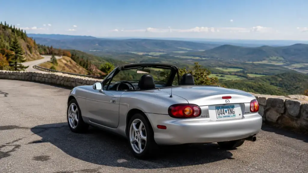 Mazda MX-5 Miata parked on a mountain pass compared against a Porsche Boxster.