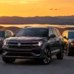 Volkswagen Atlas standing alongside Hyundai Palisade and Kia Telluride on a scenic overlook