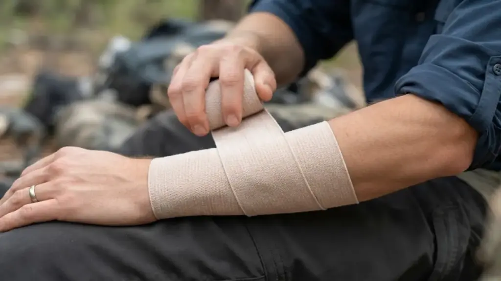 applying-elastic-compression-wrap-firmly-over-an-arm-first-aid