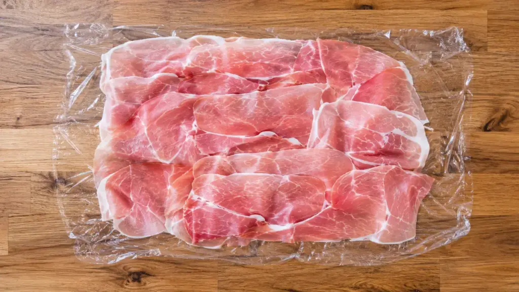 arranging-prosciutto-slices-to-create-a-moisture-barrier-for-beef-wellington-food-network