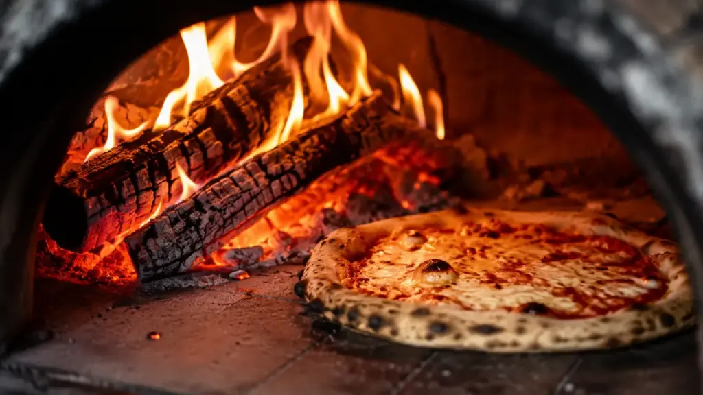 authentic-naples-stone-pizza-oven-with-burning-wood-logs-baking-an-artisan-pie