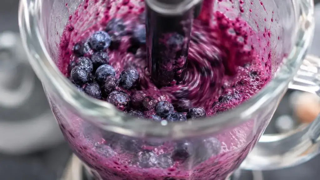blending-organic-frozen-blueberries-in-a-glass-jar