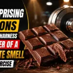 dark chocolate bar resting next to a heavy dumbbell on a wooden table