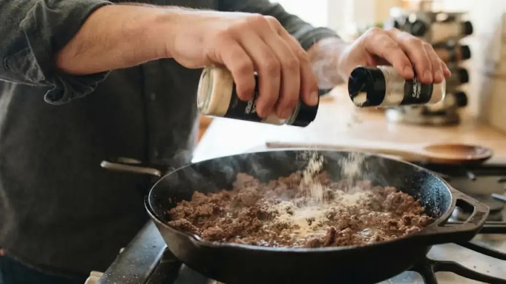 dusting-garlic-and-onion-powder-over-ground-beef-for-a-sloppyjoe