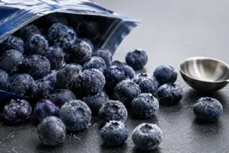 frozen organic blueberries spilled on a clean slate countertop during recall