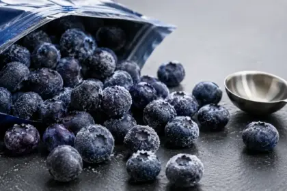 frozen organic blueberries spilled on a clean slate countertop during recall