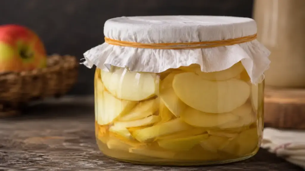 glass-fermentation-jar-with-breathable-cheesecloth-lid-secured-by-a-rubber-band