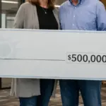 happy couple holding oversized lottery check