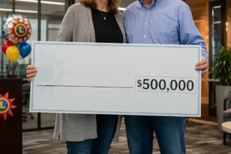 happy couple holding oversized lottery check