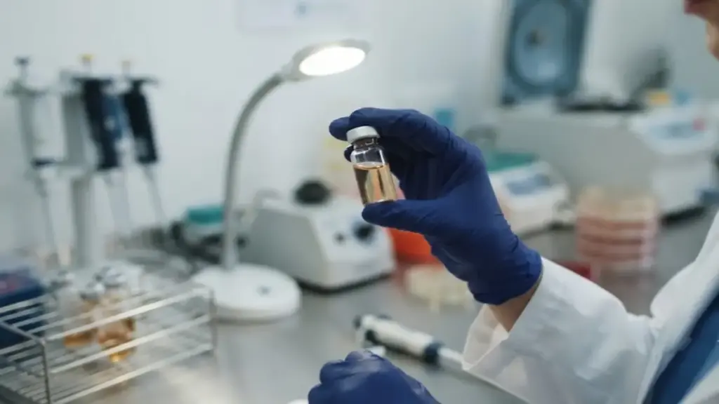laboratory-technician-inspecting-antivenom-vials-under-bright-lights