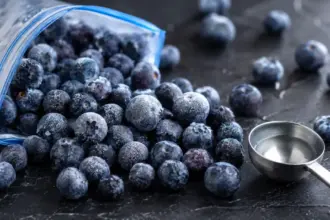 open bag of frozen blueberries spilled on a countertop