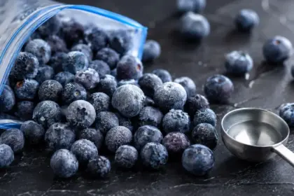 open bag of frozen blueberries spilled on a countertop