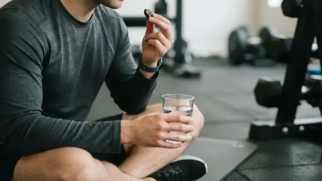 person-sitting-quietly-on-a-bench-holding-a-glass-of-fresh-water-during-a-chocolate-smell-exercise