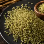 raw cracked freekeh grains on a slate plate