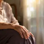 senior resting hands on knees preparing for circulation exercises