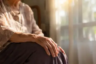senior resting hands on knees preparing for circulation exercises