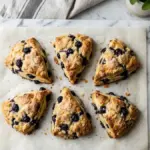 blueberry scones golden flaky pastry marble countertop